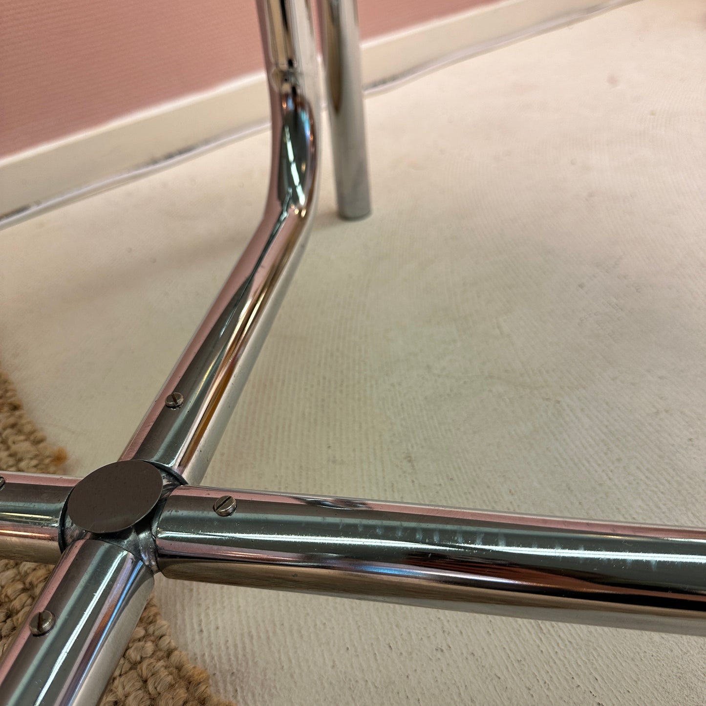 Curved tubular chrome coffee table with round glass top