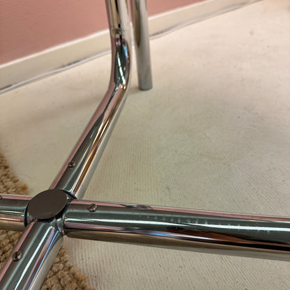 Curved tubular chrome coffee table with round glass top