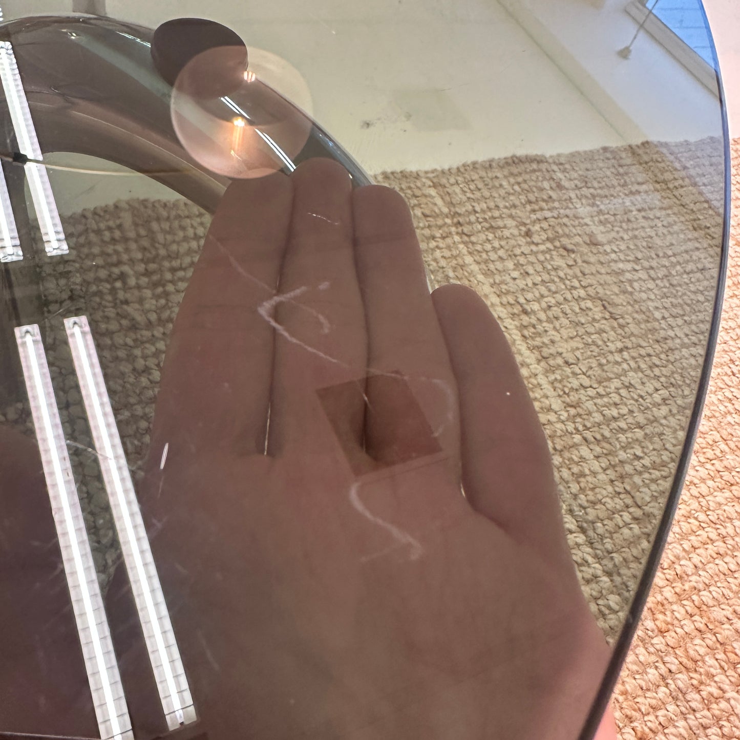 Curved tubular chrome coffee table with round glass top