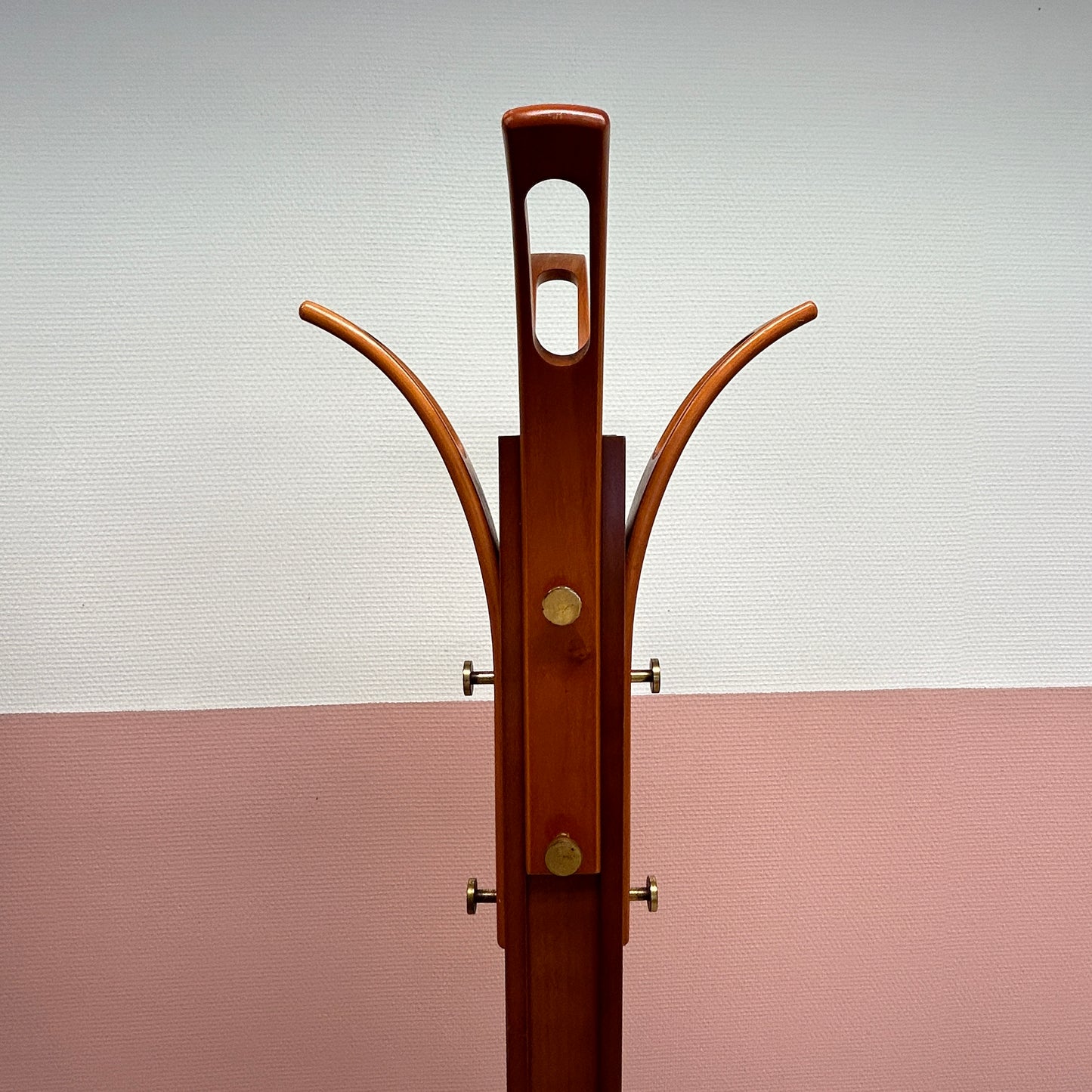 Wooden coat rack with curved top and brass hooks