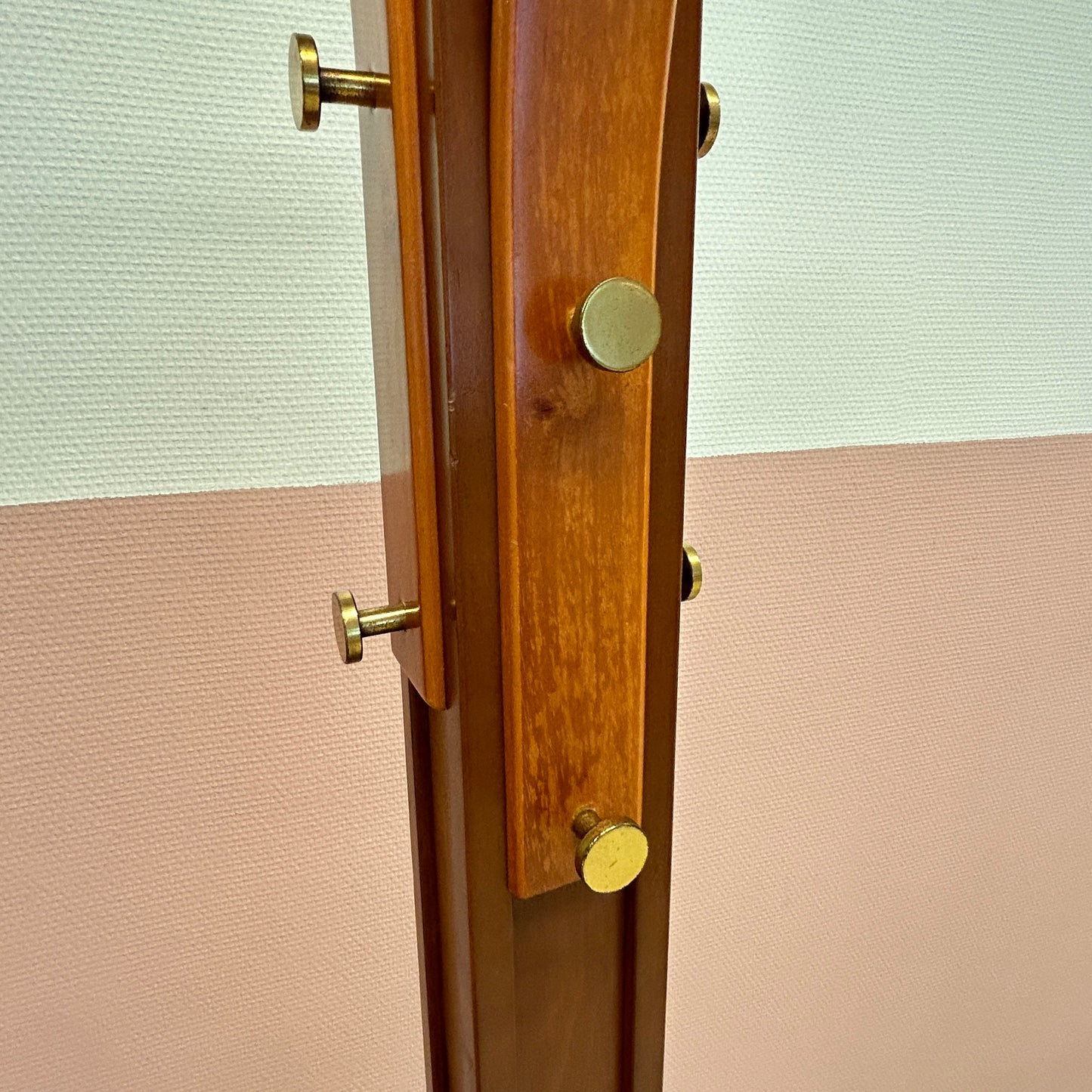 Wooden coat rack with curved top and brass hooks