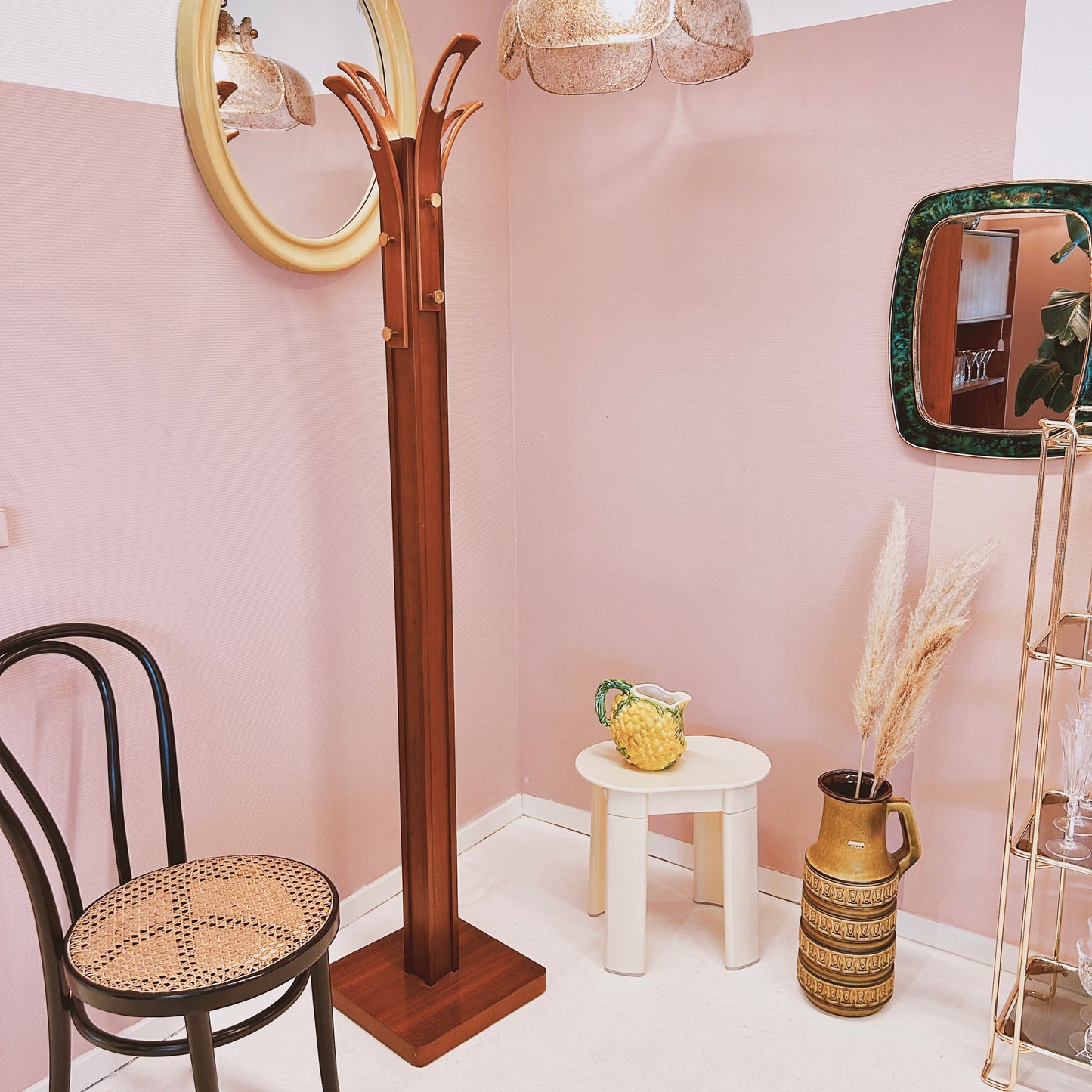 Wooden coat rack with curved top and brass hooks