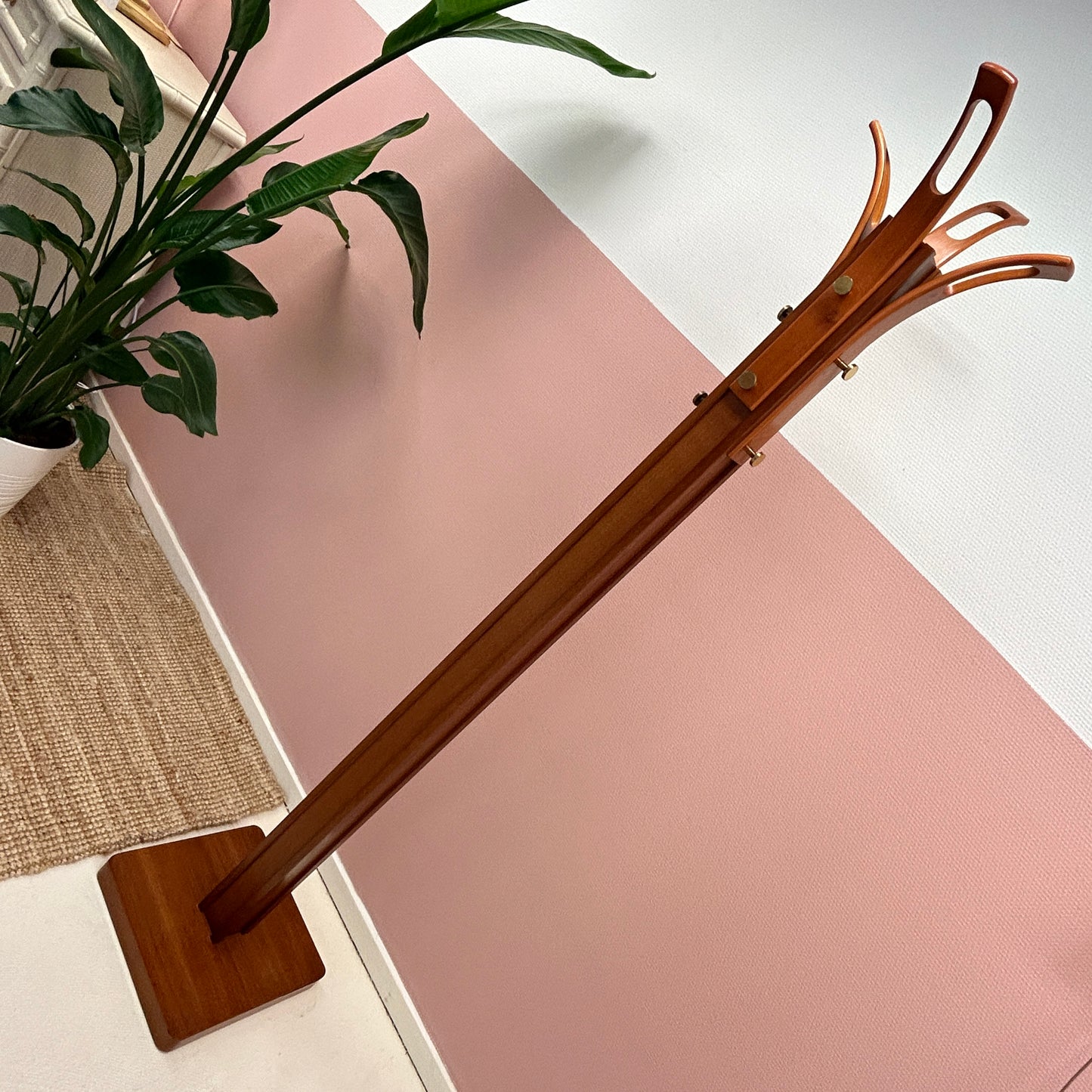 Wooden coat rack with curved top and brass hooks