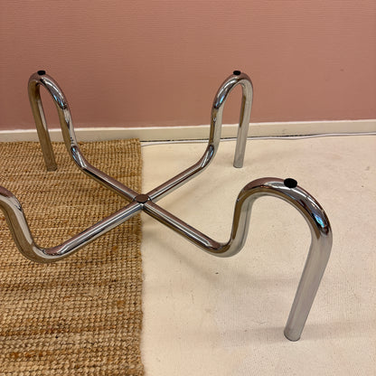 Curved tubular chrome coffee table with round glass top