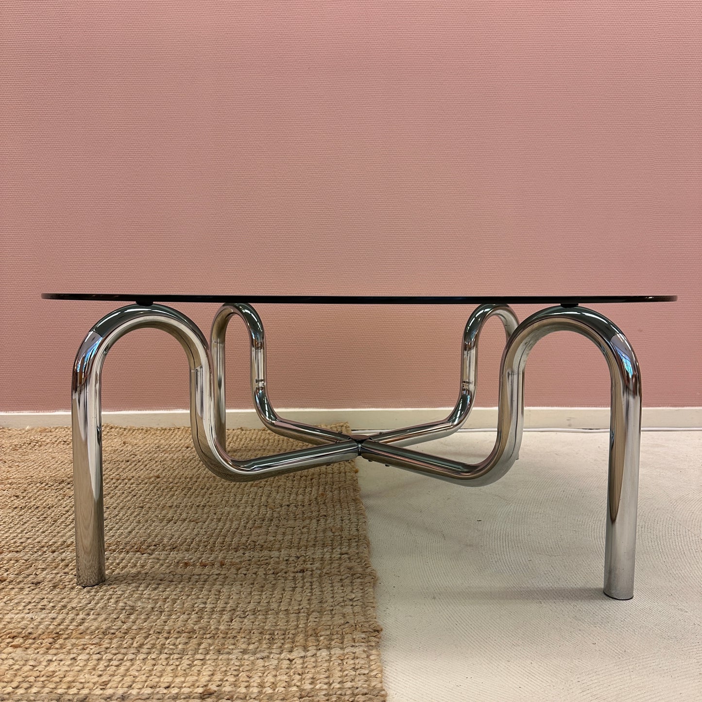 Curved tubular chrome coffee table with round glass top