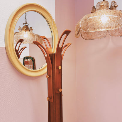 Wooden coat rack with curved top and brass hooks