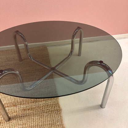 Curved tubular chrome coffee table with round glass top