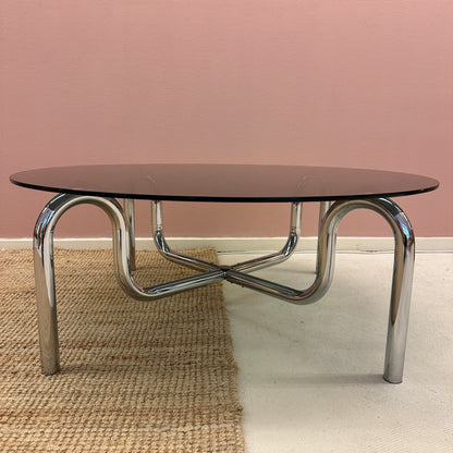 Curved tubular chrome coffee table with round glass top