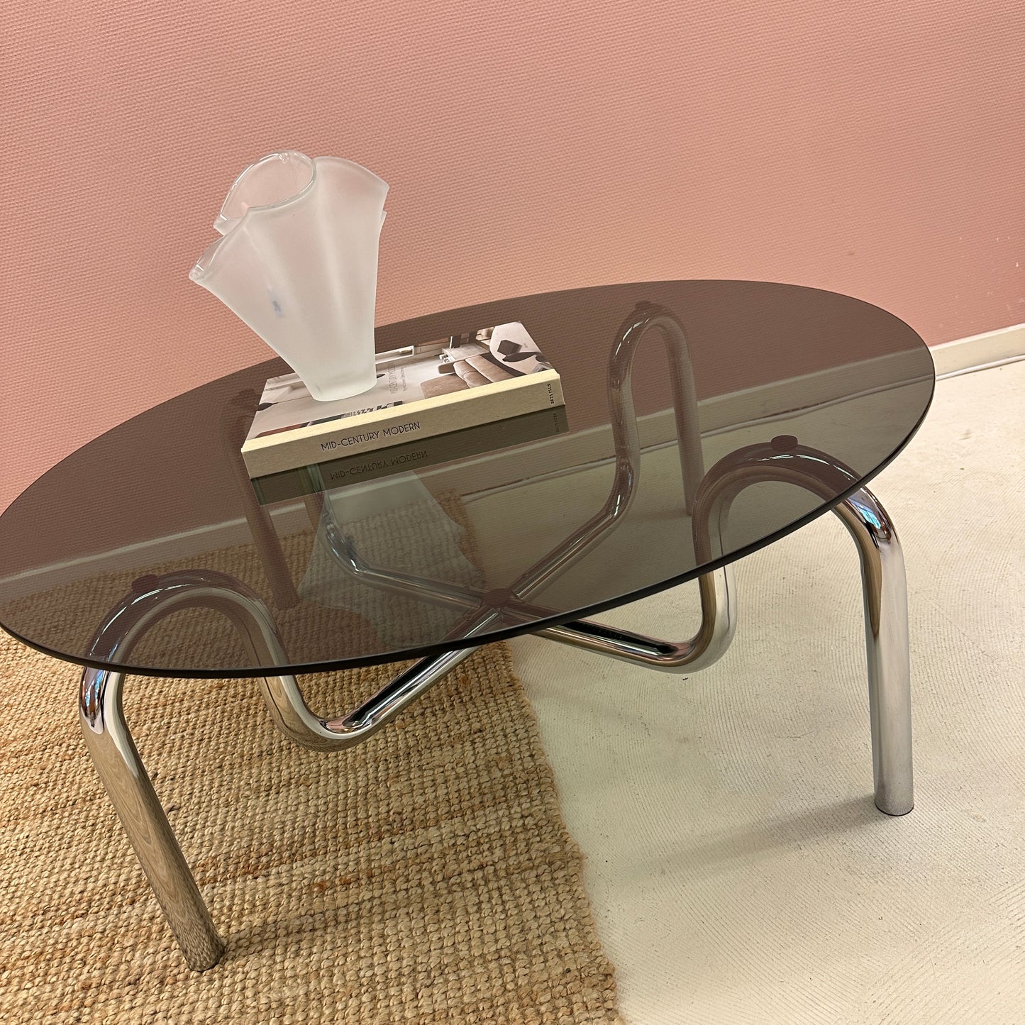 Curved tubular chrome coffee table with round glass top