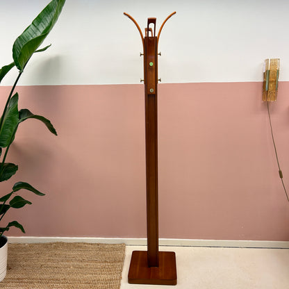 Wooden coat rack with curved top and brass hooks