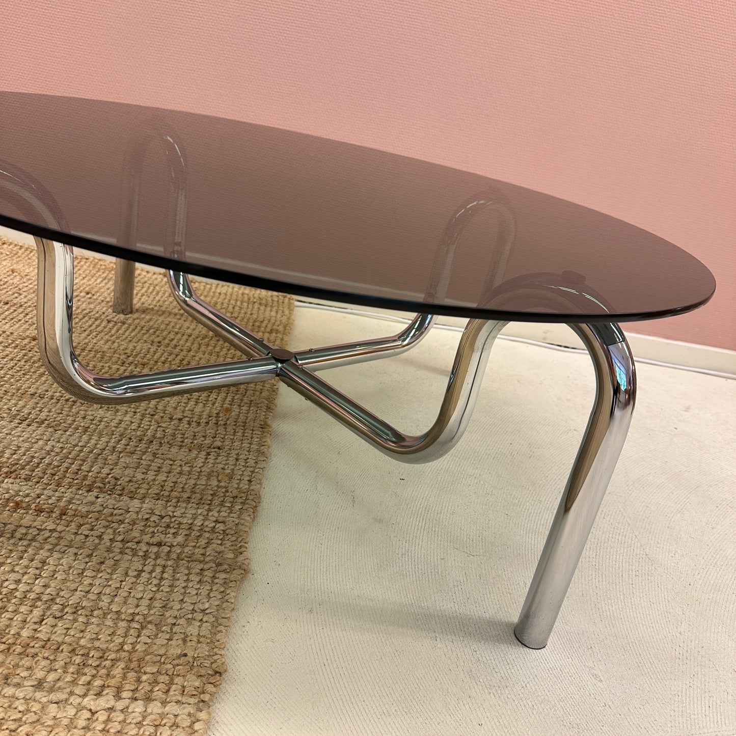 Curved tubular chrome coffee table with round glass top