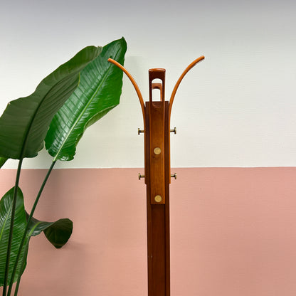 Wooden coat rack with curved top and brass hooks