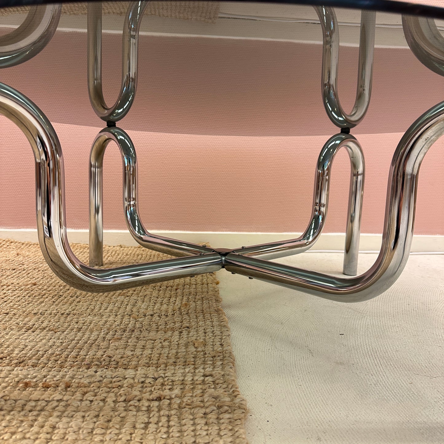 Curved tubular chrome coffee table with round glass top